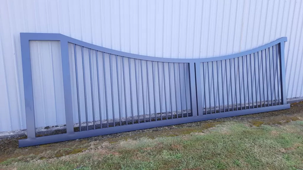 Curved-top aluminium sliding gate designed to look like a pair of swing gates