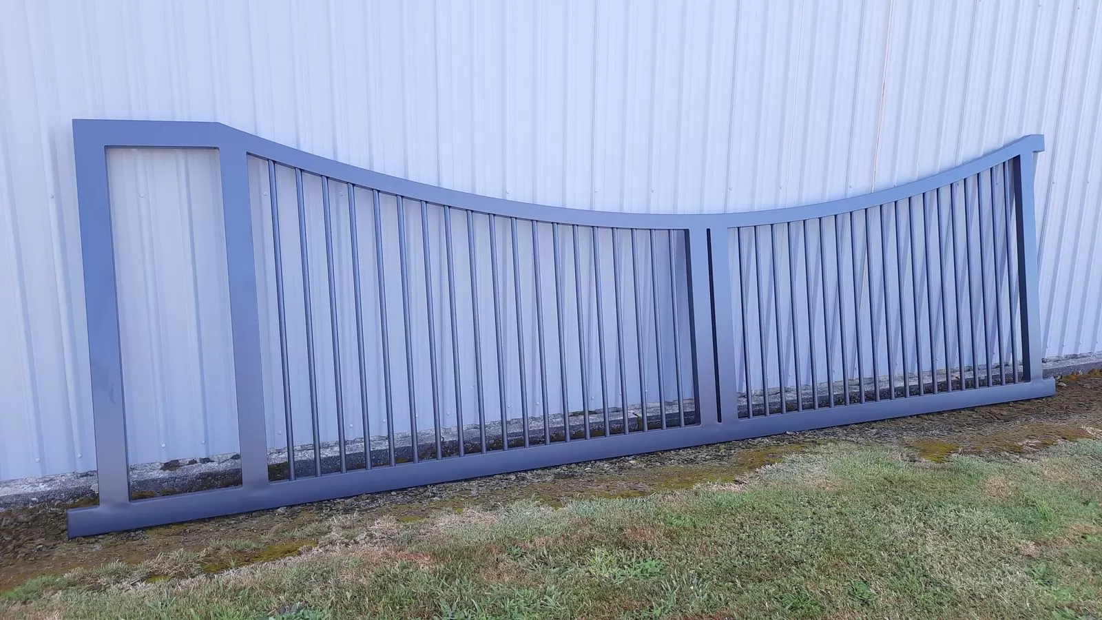 Curved-top aluminium sliding gate designed to look like a pair of swing gates