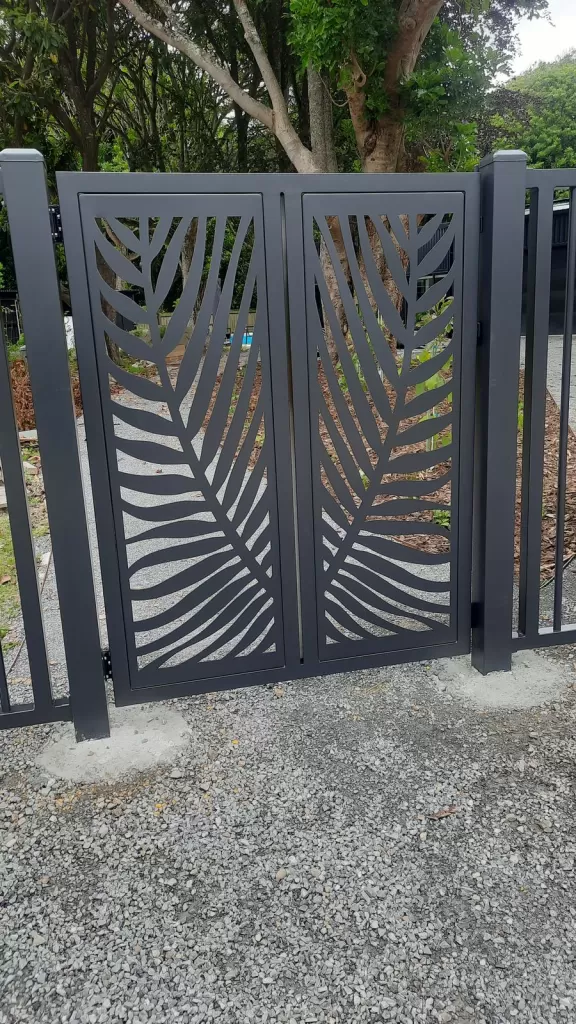 Aluminium pedestrian gate with a decorative laser-cut palm panel